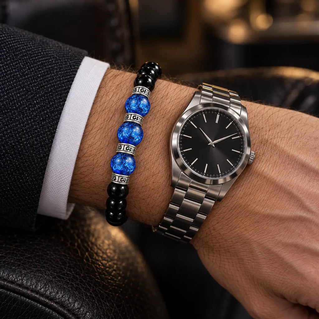 Black obsidian and blue Liuli bracelet worn beside a silver watch