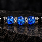 Three blue crackle Liuli beads framed by four S925 mantra rings