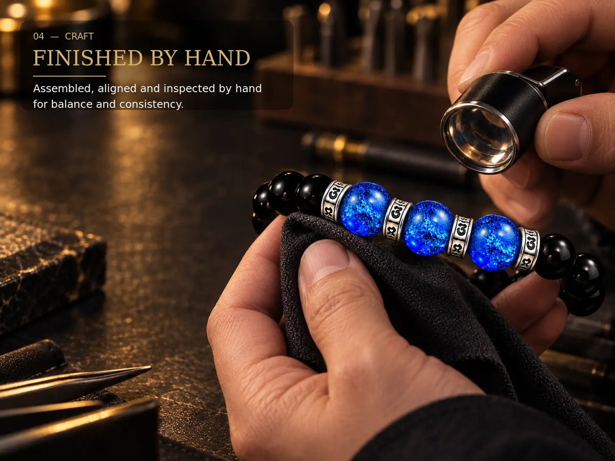 Hand inspection of black obsidian and blue Liuli bracelet