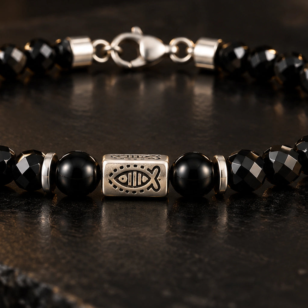 Close view of black obsidian bracelet and S925 fish-pattern silver centerpiece