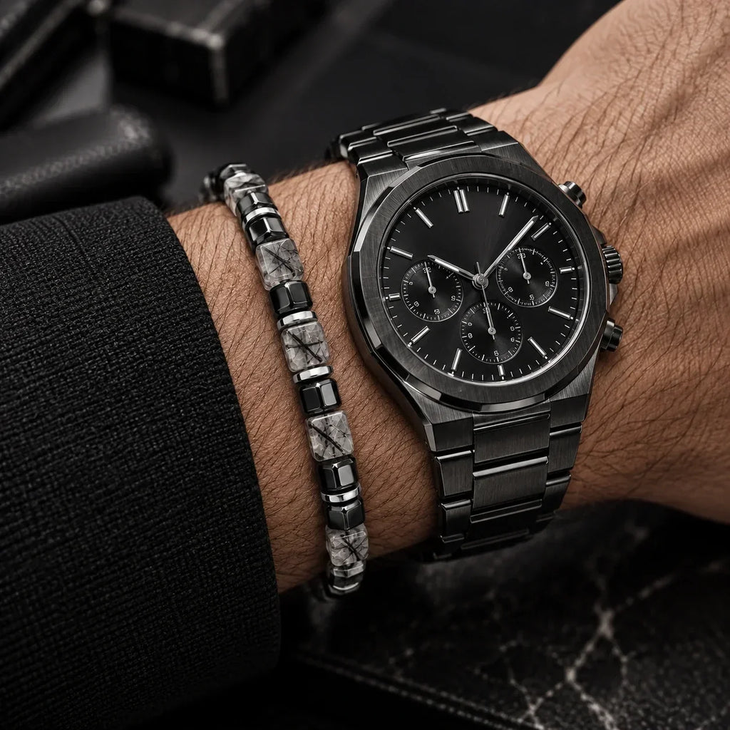 Black rutilated quartz bracelet styled beside a black watch