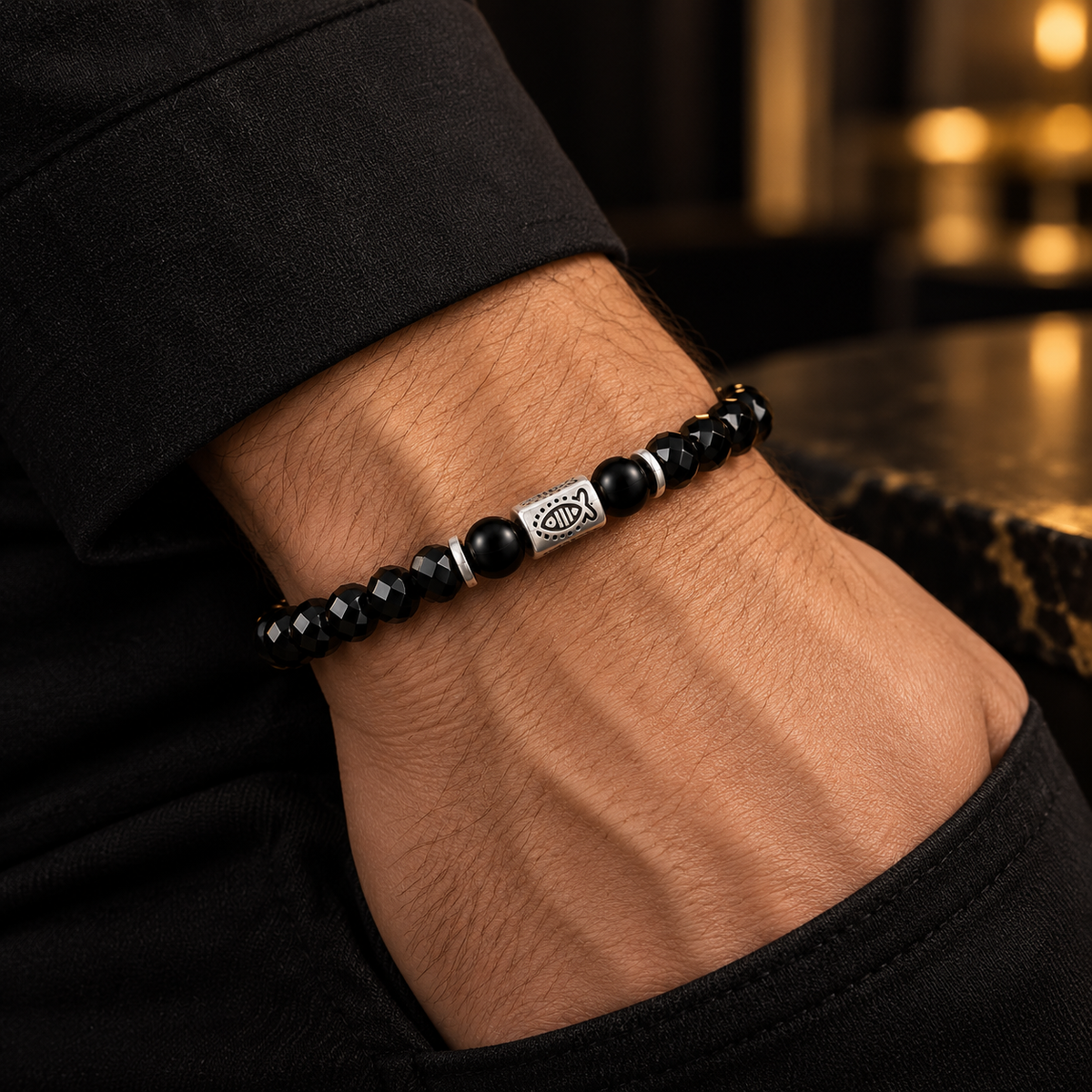 L&X black obsidian fish bracelet worn on wrist