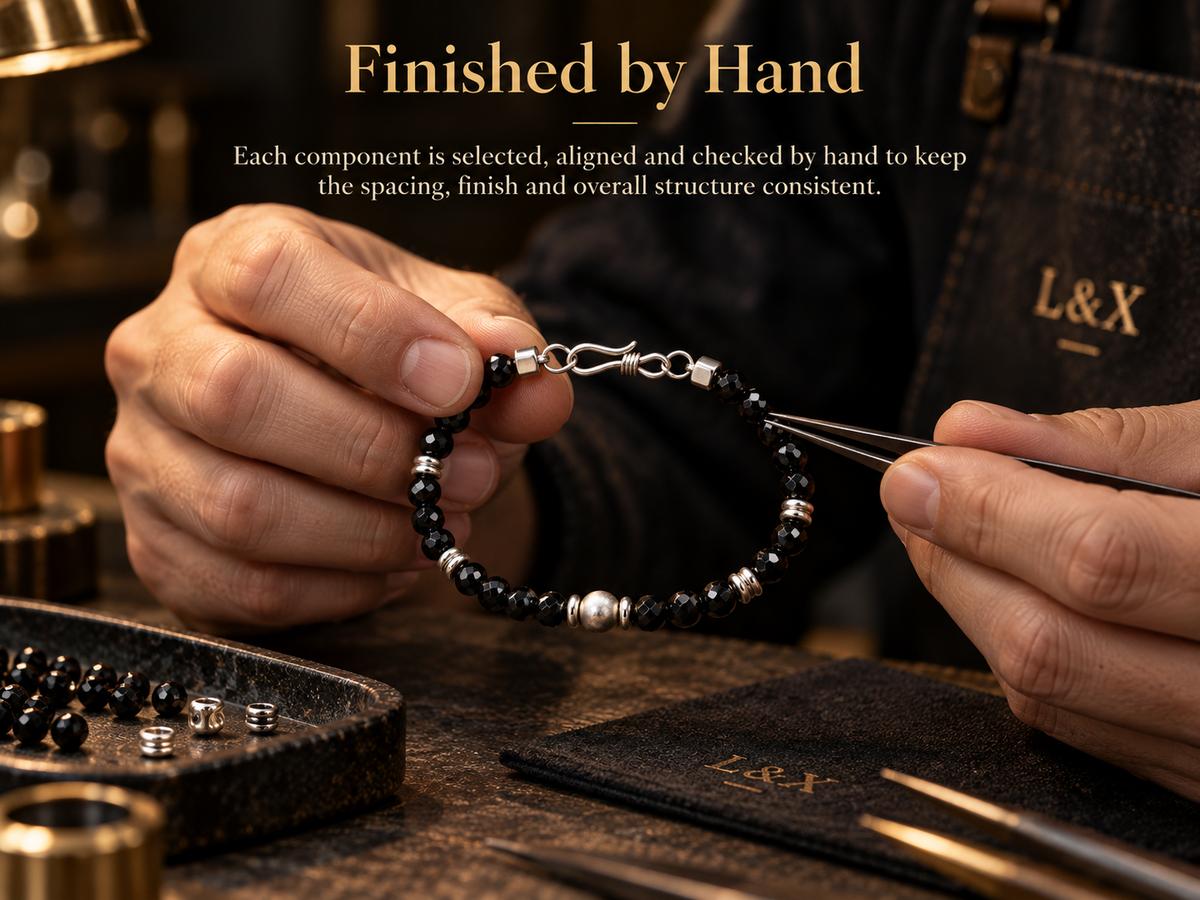 Hand-finishing black spinel bracelet in workshop