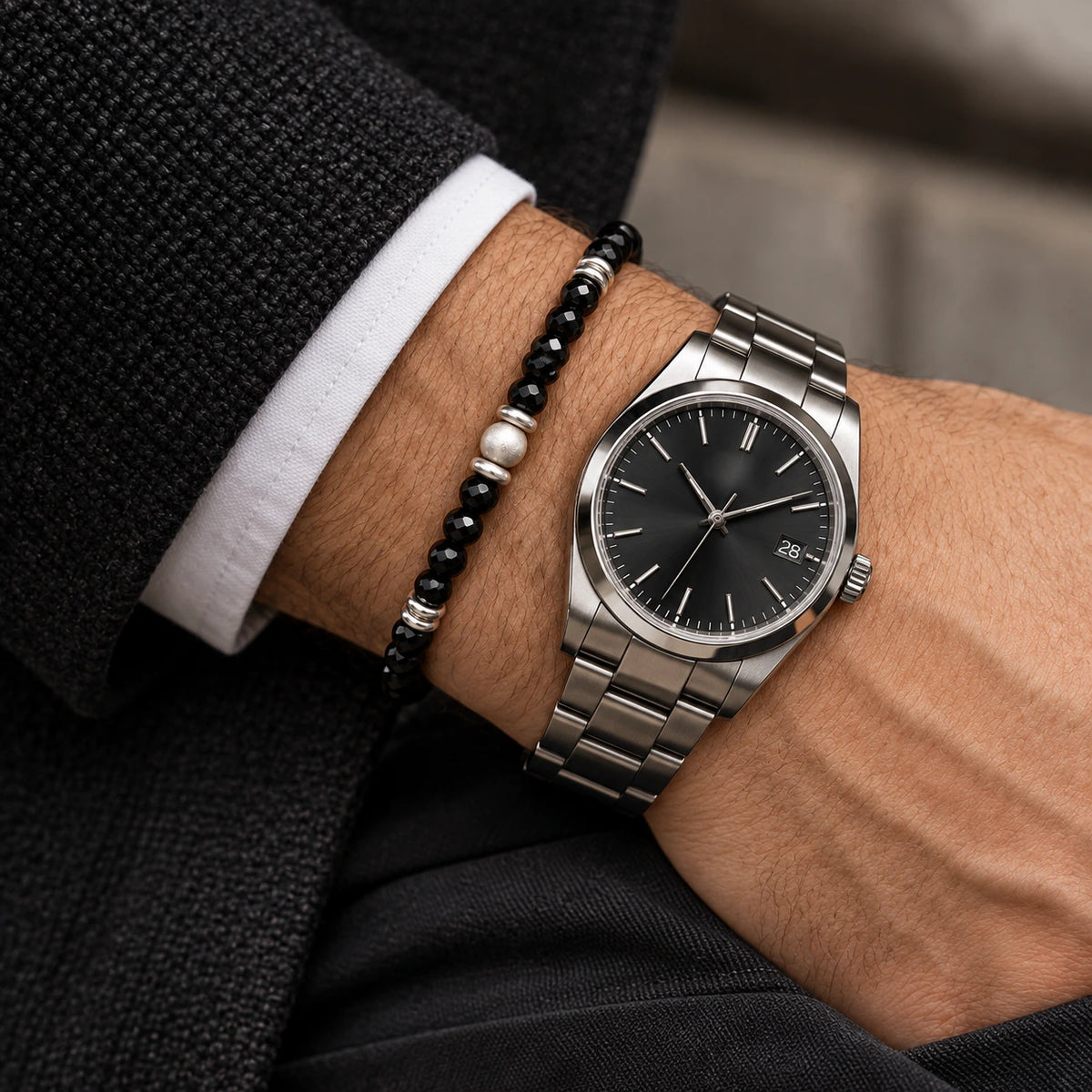 Black spinel bracelet styled beside a watch