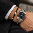 Black spinel bracelet styled beside a watch