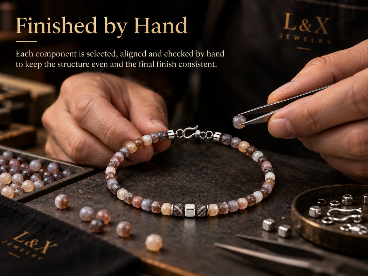 Hand-finishing Botswana agate bracelet in workshop