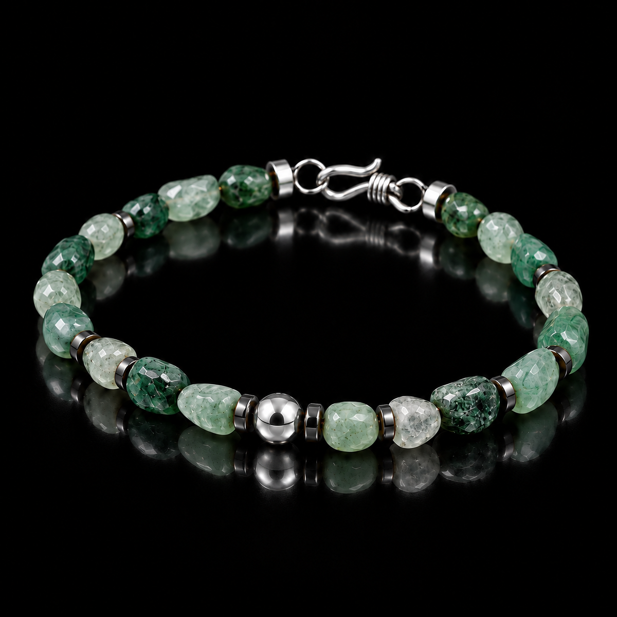 Angled view of natural freeform green agate bracelet with hematite spacers