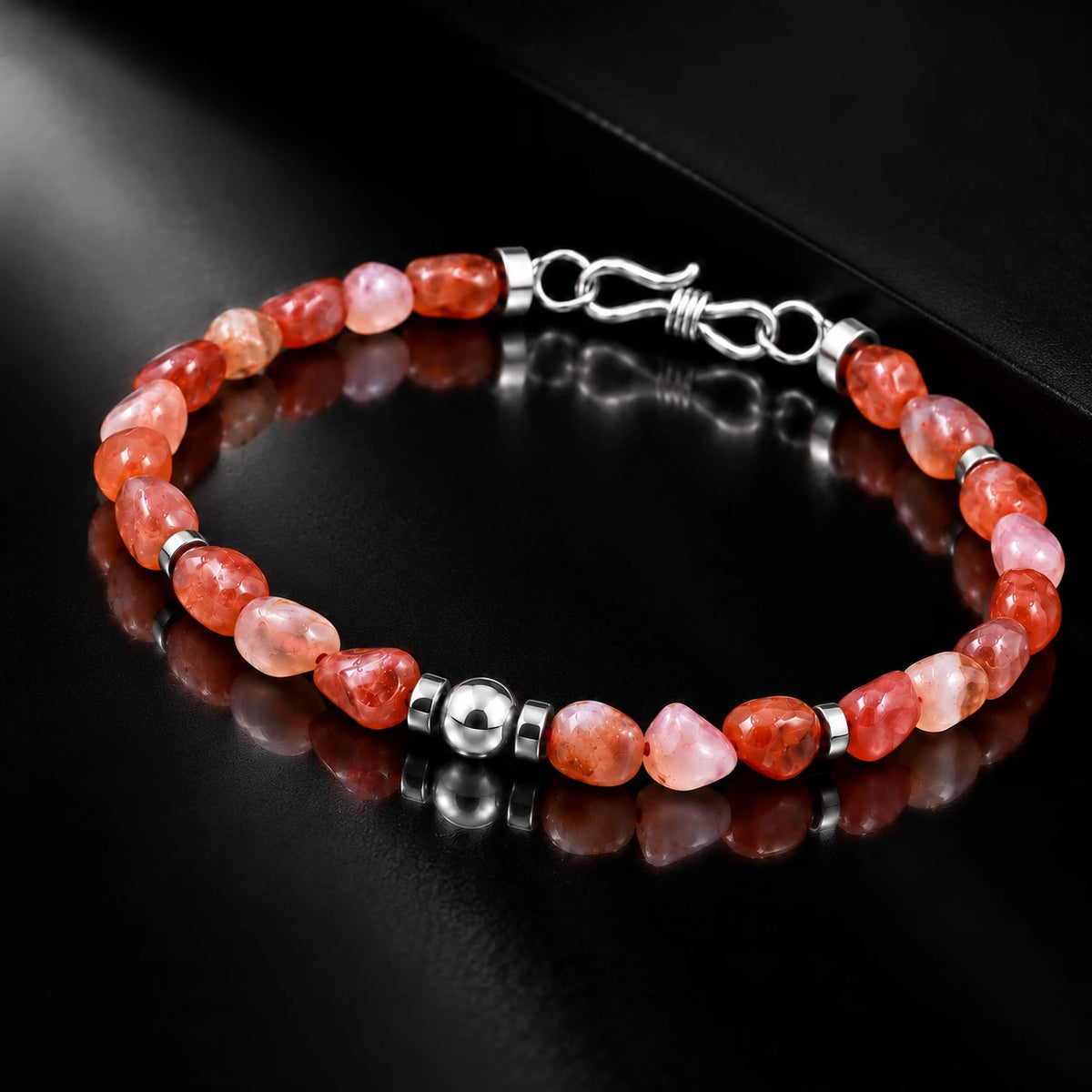 Angled view of natural freeform Nanhong agate bracelet