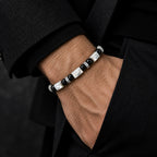 Mother-of-pearl and obsidian bracelet worn on wrist