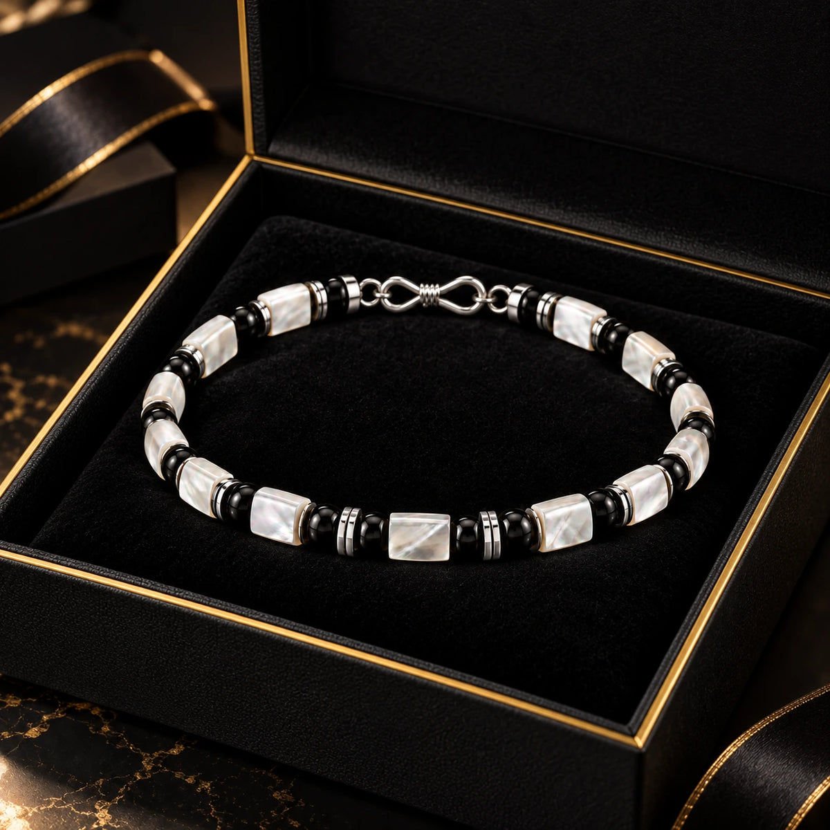 L&X mother-of-pearl obsidian bracelet in black and gold gift box