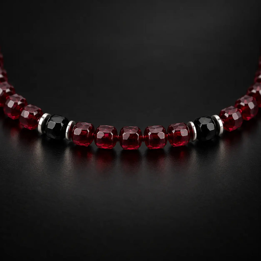 Close-up of faceted garnet, two black obsidian beads and thin S925 silver spacers.