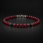 Natural garnet and black obsidian bracelet at a 45-degree angle showing faceted stone luster.