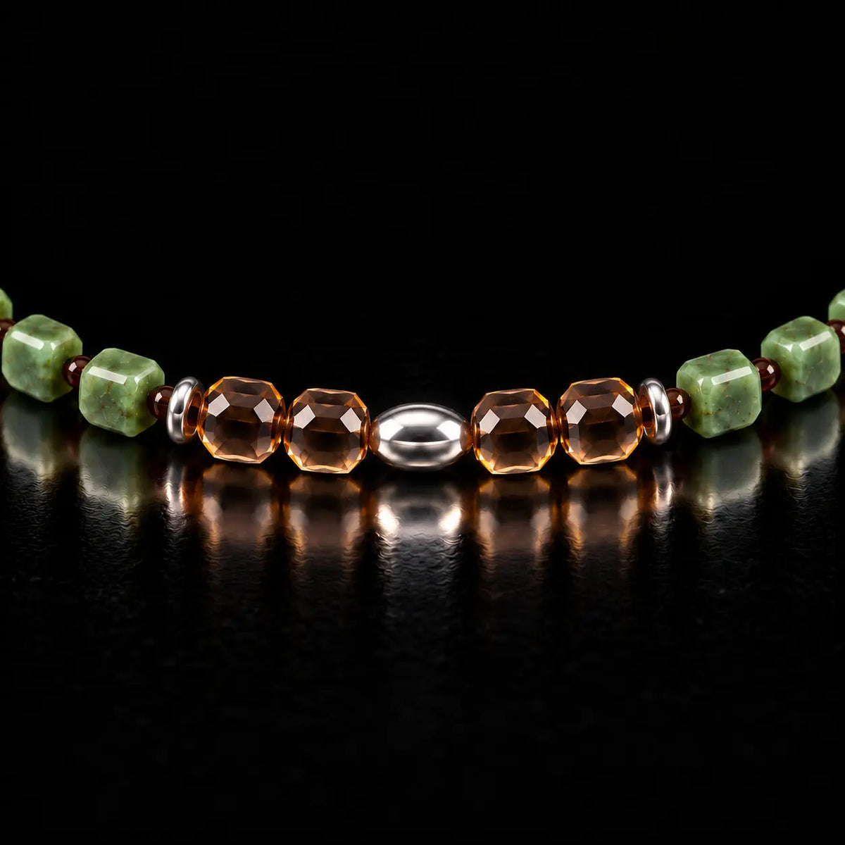Close view of four faceted smoky quartz beads and the S925 olive-shaped centre bead.