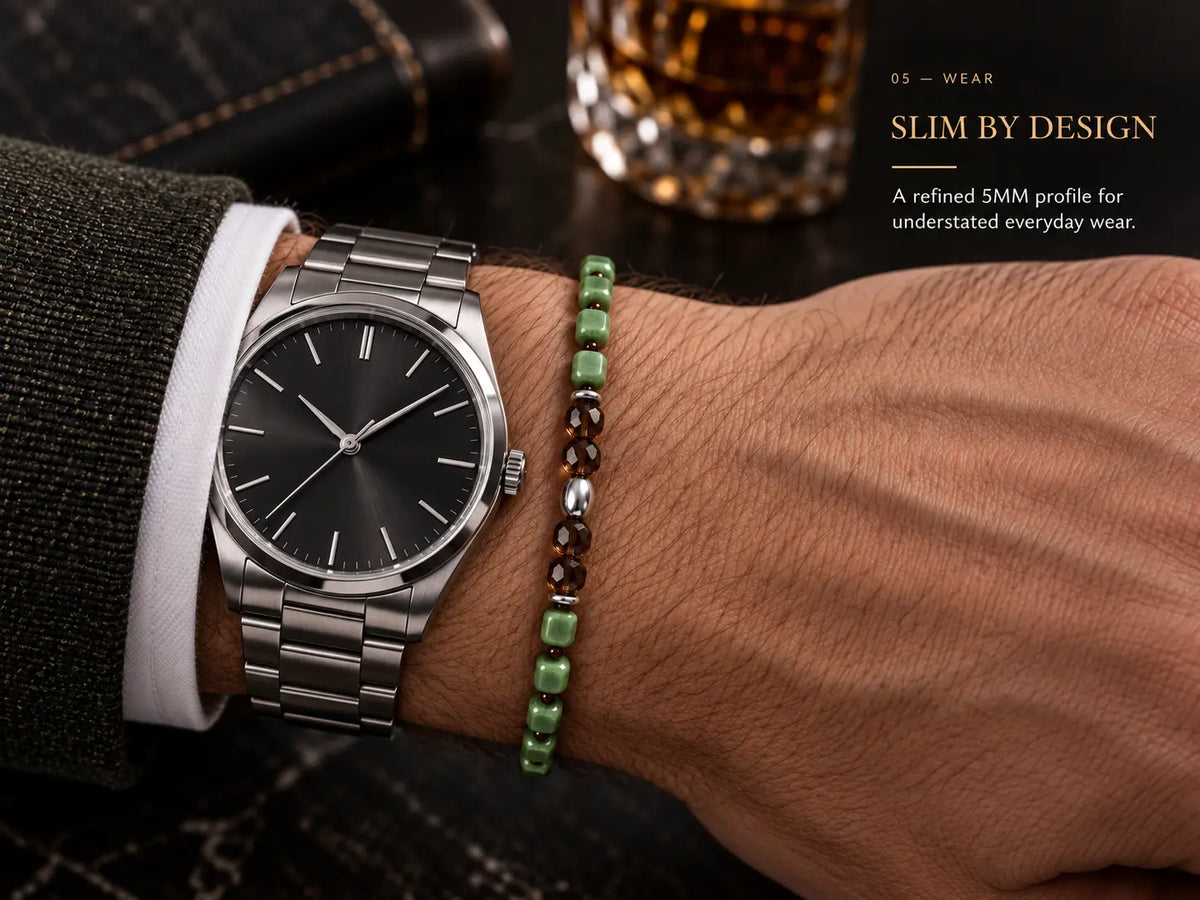 Slim natural nephrite bracelet worn with a wristwatch for everyday styling.