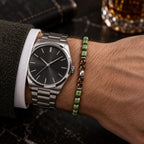 Slim 5MM nephrite jade bracelet worn beside a steel wristwatch.