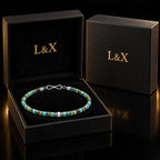 Natural turquoise cube bracelet presented inside the black and gold L&X jewelry box.