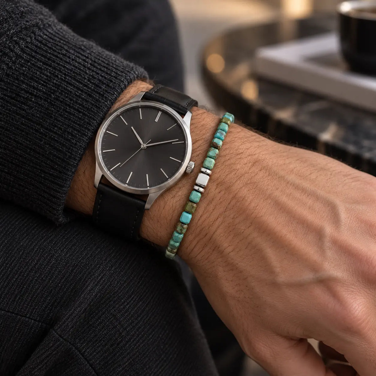 Natural turquoise cube bracelet with S925 silver center styled beside a black leather-strap wristwatch.