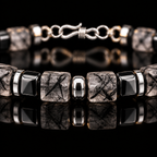 Close-up of black rutilated quartz cube beads, dark accents and selected S925 silver spacers